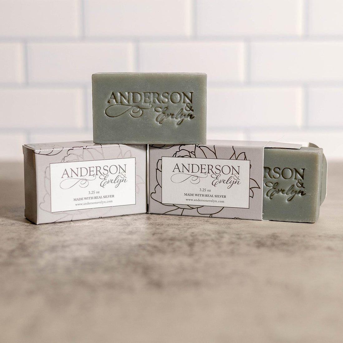 Natural green soap bars made with real silver, displayed on a marble countertop.