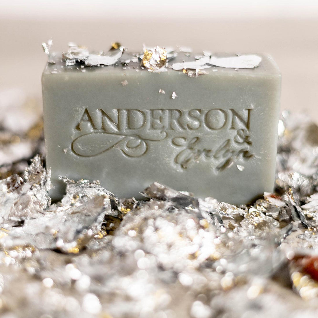 Natural soap bar with metallic flakes, engraved lettering, antimicrobial skincare product