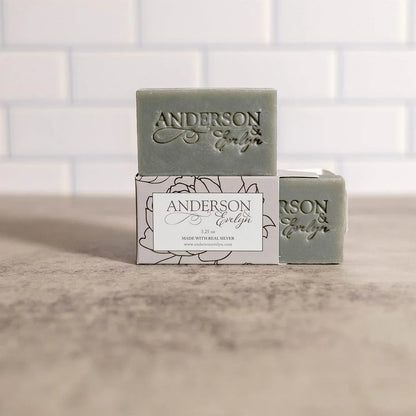 Artisan natural soap bars with Anderson Evelyn branding, displayed on a box in a clean, minimal setting