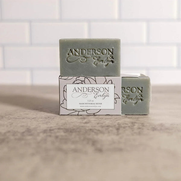 Artisan natural soap bars with Anderson Evelyn branding, displayed on a box in a clean, minimal setting
